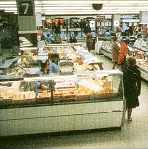 Delicatessen island counter offering lots of different cheeses featured in the major Woolworth city centre stores in the Seventies