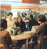 Job done and smiles all round as a couple collect their order from a Shoppers World store in 1975