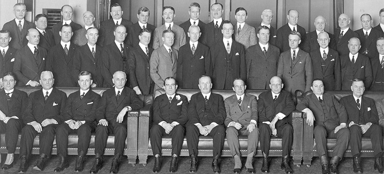 A meeting of the Executive Committee in New York. The parent Company Board are in the front row, with the Buyers and Senior Executives behind.  Among other there were two British Founders on the Board, William Stephenson, far left, and Byron De Witt Miller the second to his right, US Vice President and Head of International Operations, and three Founders of the Five and Ten Cent Stores, Sum Woolworth, Perry Charlton and Fred Kirby on the right of the centre sofa, as well as Frank Woolworth's successor Hubert Templeton Parson to their left