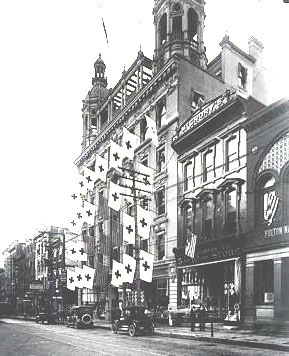 Rival dimestores in North Queen Street, Lancaster PA in 1910 - McCrory's in the foreground in front of Frank Woolworth's first skyscraper, bedecked with flags
