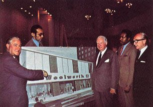 Woolworth CEO Robert C Kirkwood hands over the keys to the firm's store in Harlem to a local community group in 1969.  The move was part of a crime reduction initiative.