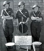 The Stirrup Pump played a crucial role in Woolworths' blitz defences during WWII.  Here three colleagues from the Newton Abbot store show off their firefighting kit after winning the county championship in Devon in 1942.  They are Mrs. E. Tucker (née Spear), Mrs. Sanders (née Clements) and Miss D. Stone.