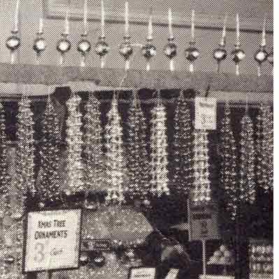 Popular Christmas Decorations from Woolworths in the 1920s - strings of beads to hang on the tree and 'finial baubles' for the top of the tree which were a glass decoration and candlestick in one.