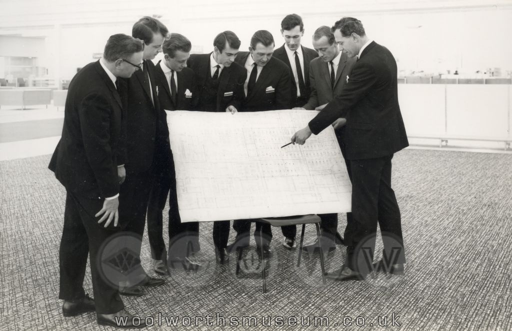 The management team inspect the huge layout plan which had been carefully drawn for Britain's largest ever Woolco store.Many of the ranges had never been sold before. Their challenge was to bring it to life !