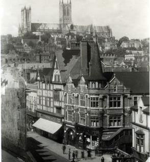 A long view of the F. W. Woolworth store in High Street, Lincoln, with the Cathedral in the background