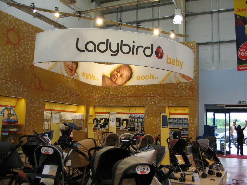 Huge directional sign highlighting the Ladybird baby ranges on the out-of-town Woolies (2005)