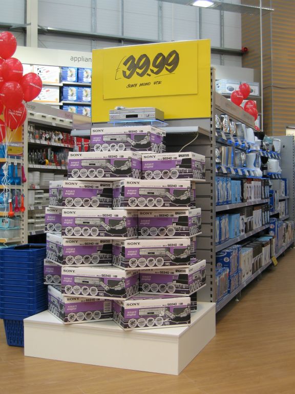 A large feature display of VHS video recorders at £39.99, as the technology rapidly went out of fashion, in a Woolworths out-of-town store in 2005