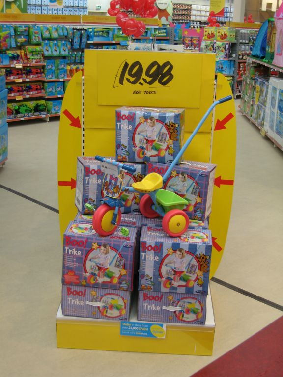 A feature display of brightly coloured kids tricycles with long guide handle, which were £19.98 at an the out-of-town Woolworths in Bristol's Imperial Park in 2005