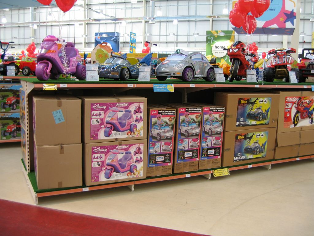 A Volkswagen nestles among this bold display of sit and ride toys in a large out-of-town Woolworths store (2005)