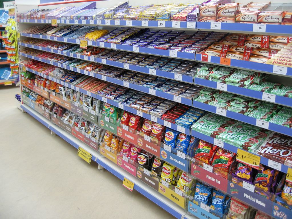 Chocolate candy bars galore, with crisps squeezed in below, on display at an out-of-town Woolworths in 2005