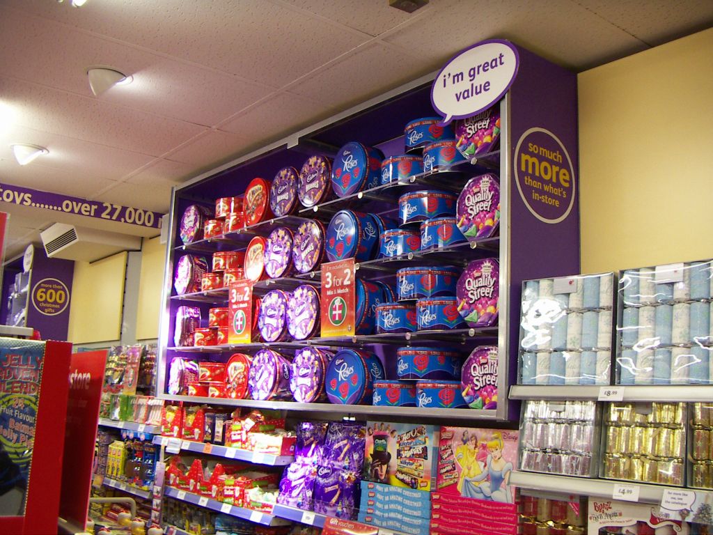 A bold display of seasonal sweets, including all-time favourites like tins of Quality Streets and Roses, alongside newer lines like Cadbury's Heroes and Celebrations, in the Kingswood Woolworths (2005)