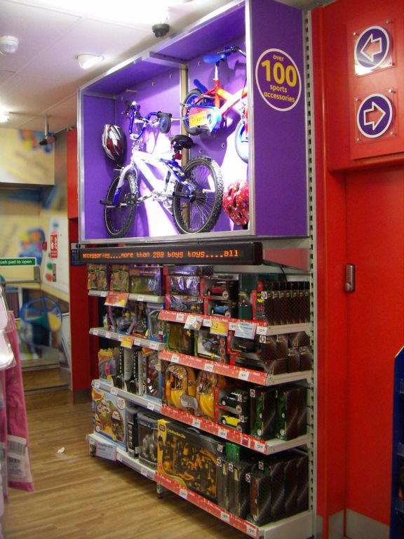 A showcase above a display of boys toys, showing the extended range that was available to order from the Kingswood Woolworths in 2005, including large items like BMX bikes