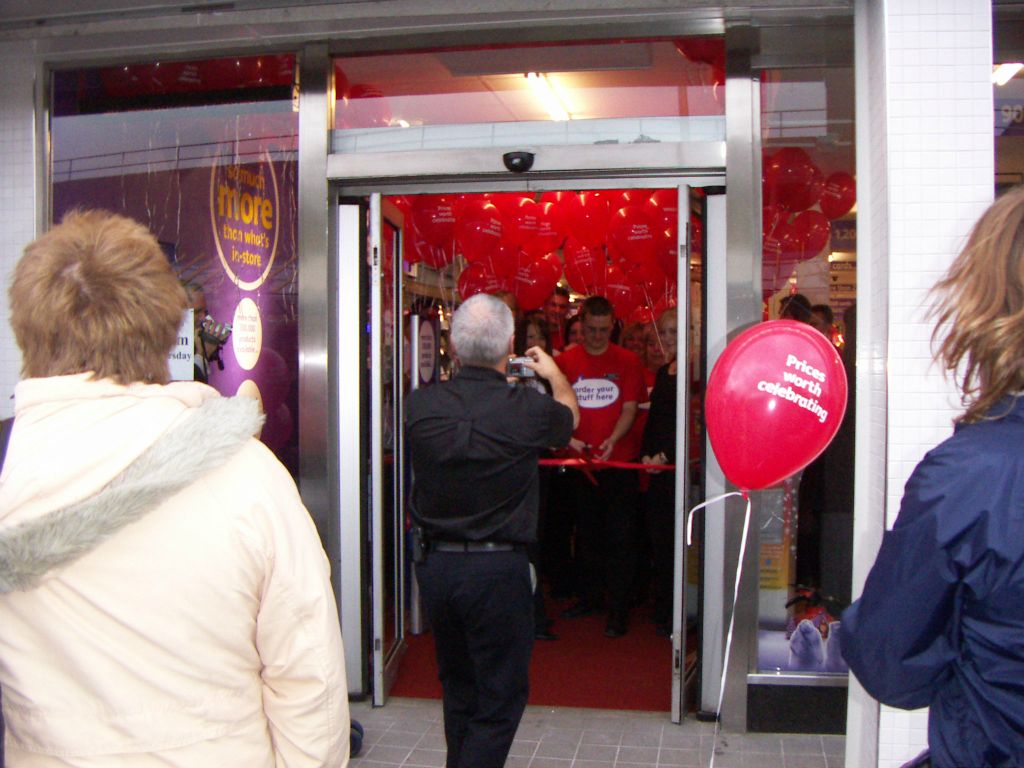 Implementation Manager David Campbell grabs a photo of the Kingswood staff before the store opened its doors after refurbishment on 5 November 2005