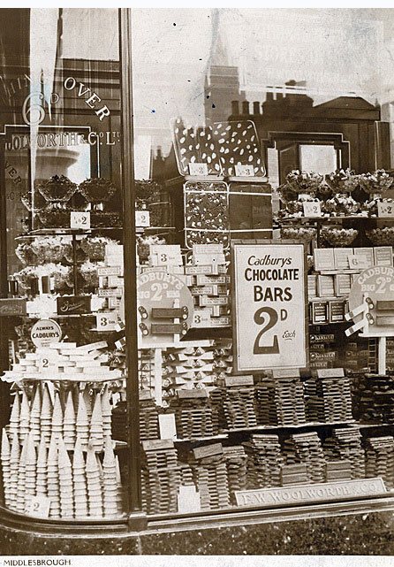 Weigh out sweets and miniature 3oz (85g) chocolate bars from Cadbury in the windows of Woolworth Middlesborough store in the early 1930s.