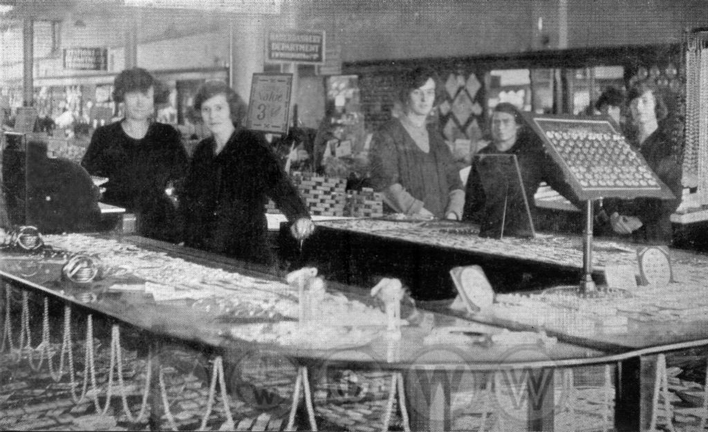 A large glass island counter of jewellery and rings at the store in Ilford High Road, in the Metropolitan Borough of Redbridge, pictured in 1924.  The branch had opened in well-appointed premises next to the Town Hall.  