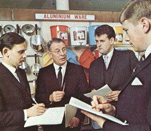 A group of young trainee managers - every one male - receive instruction from a training officer at Woolworth's Castleton in 1969