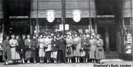 Colleagues from Woolworths at Shepherd's Bush preparing to celebrate H. M. The Queen's Coronation. In the background the store front is decorated with flags, bunting and pictures of the Queen.