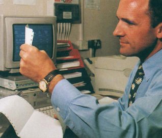 Flagship Woolworths store manager Brian Bower reviewing his store's performance at the new Back Office PC - 1992