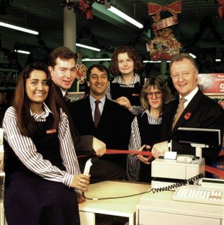 Inauguration of the EPOS system in 1994 at the final British Woolworths store to go on-line.  Looking on were the architects of the initiative, Operations Director Martin Toogood and Systems and Logistics Director, Dan Bernard