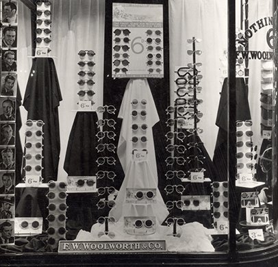 Sixpenny sunglasses in Woolworth's window in Maidenhead, Berkshire in 1937, promised they would protect shoppers' eyes from the sun's injurious rays. The low price had been achieved by using the latest wonder material, bakelite.