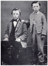 Frank Winfield Woolworth (seated) and his brother Charles Sumner Woolworth (standing), pictured in the parlour of the family home in 1866