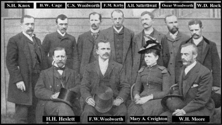 Managers' convention in Frank Woolworth's back yard in 1884 - the founding fathers of the five and ten cent business. Back row left to right: S.H. Knox, B.W. Cage, C.S. Woolworth, F.M. Kirby, A.H. Satterthwait, Oscar Woodworth, W.D. Rock. Front row: H.H. Heslett, F.W. Woolworth, Mary A Creighton and W.H. Moore
