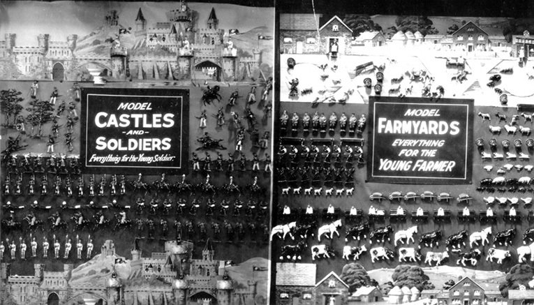 A toys window from Christmas 1937, featuring castle and lead soldiers on the left and another range from Britain's on the right - a selection of farmyard animals made from lead