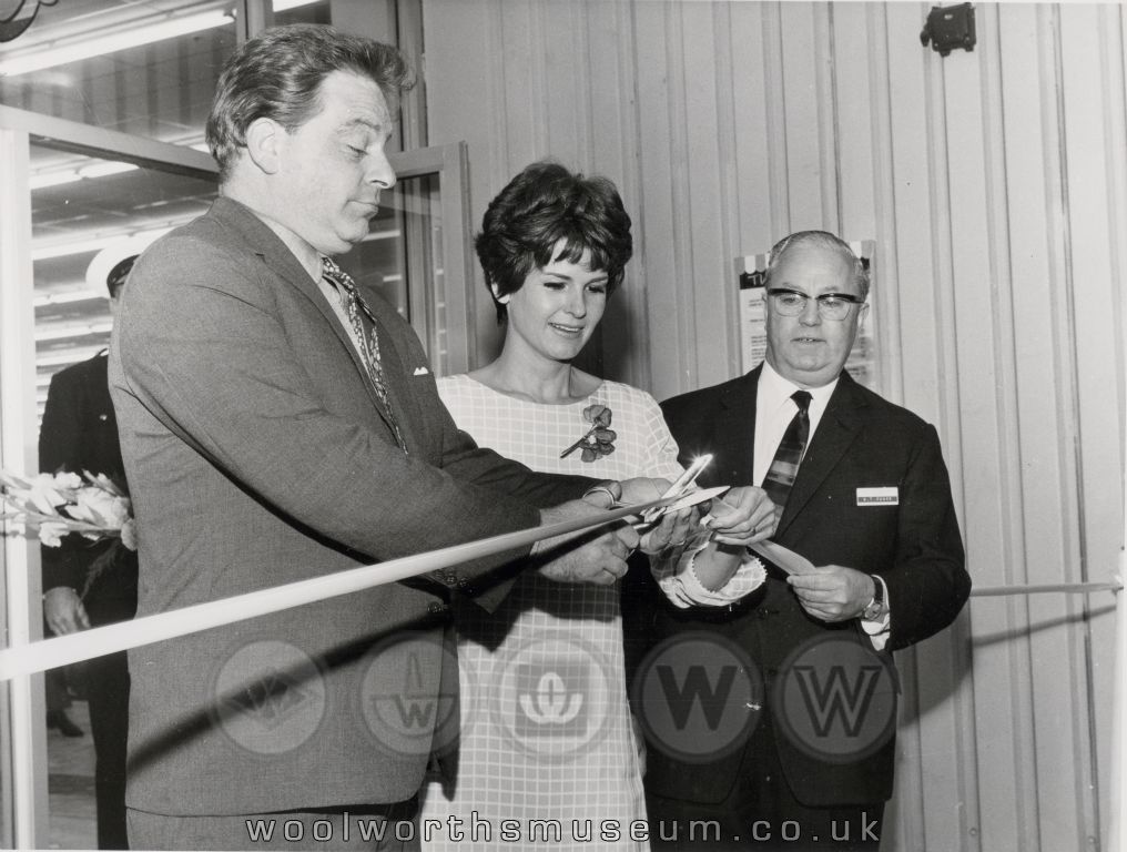 Katie and Phillip from the popular sixties OXO advertisements prepare to cut the ribbon at Woolco Thornaby, with Mr G.T. Cooke, Woolco's Advertising Manager (who had arranged the appearance) looking on